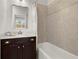 This modern bathroom features stylish tiling, a vanity with a white countertop, and a shower at 4000 Bethelview Ln, Suwanee, GA 30024
