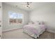 Cozy bedroom with a ceiling fan, large window for natural light, and soft carpet at 4000 Bethelview Ln, Suwanee, GA 30024