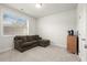 Comfortable bonus room with a large window, neutral carpet, and a cozy sectional at 4000 Bethelview Ln, Suwanee, GA 30024