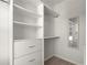 Bright walk-in closet featuring custom shelving, drawers, and a full length mirror at 4000 Bethelview Ln, Suwanee, GA 30024