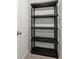 A black plastic shelf stands tall inside of this modest closet space at 4000 Bethelview Ln, Suwanee, GA 30024