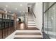 Bright foyer featuring hardwood floors, staircase, and a view into the open-concept living spaces at 4000 Bethelview Ln, Suwanee, GA 30024