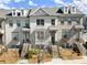 Townhome exterior showcasing brick facade, covered entryways, and landscaped front yards on a sunny day at 4000 Bethelview Ln, Suwanee, GA 30024