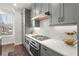 Galley style kitchen featuring stainless steel appliances, modern cabinets, and quartz countertops at 4000 Bethelview Ln, Suwanee, GA 30024