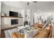 Bright living room featuring a stone fireplace, TV, and sleek modern furniture at 4000 Bethelview Ln, Suwanee, GA 30024