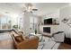 Cozy living room featuring hardwood floors, a fireplace, and a comfortable seating arrangement at 4000 Bethelview Ln, Suwanee, GA 30024