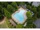 Aerial view of the large community pool area surrounded by ample seating and trees at 7315 Cordery Rd, Cumming, GA 30040