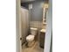 This bathroom features a tiled wall, neutral paint, and a framed mirror above the sink at 330 9Th Ne St # 11, Atlanta, GA 30309