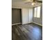 Bright bedroom with a ceiling fan, wood-look flooring, and a double-door closet at 330 9Th Ne St # 11, Atlanta, GA 30309
