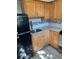 Galley style kitchen boasts stainless steel appliances, light wood cabinets, dark hardware and tile flooring at 330 9Th Ne St # 11, Atlanta, GA 30309