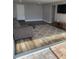 Cozy living room featuring hard wood floors, a grey sofa, large colorful rug, and tv and stand at 330 9Th Ne St # 11, Atlanta, GA 30309