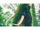 An outdoor sculpture of a woolly mammoth completely crafted from living plants at 330 9Th Ne St # 11, Atlanta, GA 30309