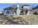 The back exterior of the home has lots of windows, a covered patio, and a large yard at 1541 Towne Park Ct, Lawrenceville, GA 30044