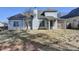 The back exterior of the home has lots of windows, a covered patio, and a large yard at 1541 Towne Park Ct, Lawrenceville, GA 30044