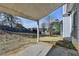 View of the backyard and patio of home with fenced perimeter and some bare trees at 1541 Towne Park Ct, Lawrenceville, GA 30044