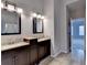 Modern bathroom featuring double vanities with granite countertops and dark wood cabinetry at 1541 Towne Park Ct, Lawrenceville, GA 30044