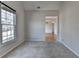 This carpeted bedroom features neutral walls and a view of the neighborhood at 1541 Towne Park Ct, Lawrenceville, GA 30044