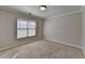 Bright, cozy bedroom featuring neutral paint and plush carpet, illuminated by natural light at 1541 Towne Park Ct, Lawrenceville, GA 30044