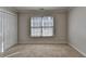 Well-lit bedroom featuring carpeted floors, a window with blinds, and a closet at 1541 Towne Park Ct, Lawrenceville, GA 30044