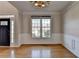 Dining room with hardwood floors, a chandelier, wainscoting, and natural light from a window at 1541 Towne Park Ct, Lawrenceville, GA 30044