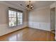Dining room with hardwood floors, a classic chandelier, and wainscoting at 1541 Towne Park Ct, Lawrenceville, GA 30044