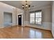 Open dining area with hardwood floors, a chandelier, and a view of the front entrance at 1541 Towne Park Ct, Lawrenceville, GA 30044