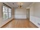 Bright dining area with large window, hardwood floors, and a classic chandelier at 1541 Towne Park Ct, Lawrenceville, GA 30044