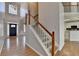 Inviting foyer with hardwood floors, grand staircase, and a view into the adjacent living spaces at 1541 Towne Park Ct, Lawrenceville, GA 30044