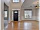 Bright foyer with hardwood floors, a chandelier, and ample natural light from large windows at 1541 Towne Park Ct, Lawrenceville, GA 30044
