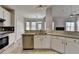 Spacious kitchen featuring stainless appliances, granite counters, and white cabinets at 1541 Towne Park Ct, Lawrenceville, GA 30044