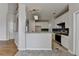 Open kitchen concept with tile floor, white cabinets, stainless appliances, and stone countertops at 1541 Towne Park Ct, Lawrenceville, GA 30044