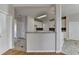 Open kitchen features tile floor, granite counters, white cabinetry and stainless steel appliances at 1541 Towne Park Ct, Lawrenceville, GA 30044