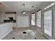 Eat in kitchen featuring white cabinets, black backsplash, stainless appliances and exterior access door at 1541 Towne Park Ct, Lawrenceville, GA 30044
