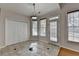 Bright eat in area featuring natural light, neutral tile floor, an exterior access door, and closet at 1541 Towne Park Ct, Lawrenceville, GA 30044
