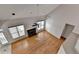 Bright living room with fireplace and hardwood floors, bathed in natural light from large windows at 1541 Towne Park Ct, Lawrenceville, GA 30044