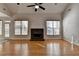 This open living room features hardwood floors and a stone fireplace at 1541 Towne Park Ct, Lawrenceville, GA 30044