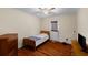 Cozy bedroom with a ceiling fan, wood-look floors, and door to the exterior at 2745 Davenport Rd, Duluth, GA 30096