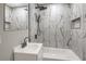 Modern bathroom showcasing stylish black and white tile, sleek fixtures, and a bathtub at 444 Sargent Se Dr, Atlanta, GA 30315