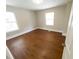 Bedroom with two windows bringing in an abundance of natural light and new flooring at 444 Sargent Se Dr, Atlanta, GA 30315