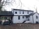 Back exterior of the home featuring white siding and covered parking at 444 Sargent Se Dr, Atlanta, GA 30315