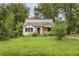 Charming home with a front yard, featuring a covered porch and mature trees at 444 Sargent Se Dr, Atlanta, GA 30315