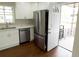 Bright kitchen features stainless steel appliances, white cabinets, and an adjacent entrance at 444 Sargent Se Dr, Atlanta, GA 30315