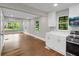Bright kitchen with white cabinets, stainless steel appliances, and hardwood floors at 444 Sargent Se Dr, Atlanta, GA 30315