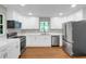 Well-lit kitchen features white cabinets, stainless steel appliances, and modern countertops at 444 Sargent Se Dr, Atlanta, GA 30315