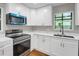 This bright kitchen features stainless steel appliances, modern countertops, and natural lighting at 444 Sargent Se Dr, Atlanta, GA 30315