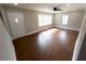Spacious living room featuring large windows that bring in natural light, paired with lovely wood flooring at 444 Sargent Se Dr, Atlanta, GA 30315