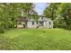 The rear exterior showing a large, green backyard and home with carport at 444 Sargent Se Dr, Atlanta, GA 30315