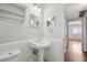 Traditional bathroom with a pedestal sink, tiled accents, and nearby bedroom access at 91 Rumson Ne Rd # C32, Atlanta, GA 30305