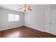 Cozy bedroom with a ceiling fan, window, hardwood floors, and double door closet at 91 Rumson Ne Rd # C32, Atlanta, GA 30305