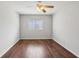 Bright bedroom featuring a ceiling fan, window, and hardwood floors at 91 Rumson Ne Rd # C32, Atlanta, GA 30305